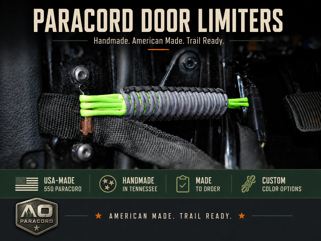 Black, gray, and neon green paracord door limiter installed inside a Jeep Wrangler, handmade with USA-made 550 paracord.