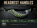 Handmade black, gray, and neon green paracord handle installed on a Jeep Wrangler or vehicle headrest, compatible with any two-post headrest.